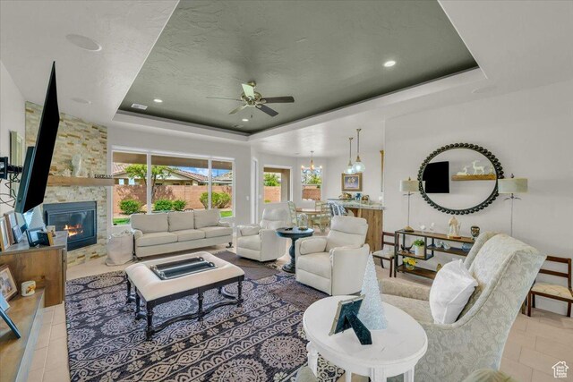875 E Roadrunner Dr, Washington, UT 84780 - living room with a stone fireplace, ceiling fan, recessed lighting, and a raised ceiling