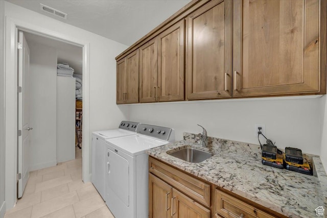 875 E Roadrunner Dr, Washington, UT 84780 - clothes washing area featuring washing machine and dryer, a sink, light tile patterned floors, visible vents, and cabinet space