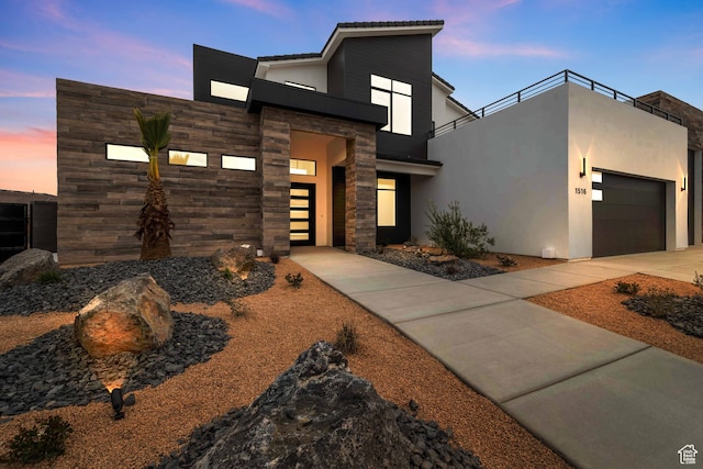 1516 W 800th Cir S, Hurricane, UT 84737 - contemporary home featuring concrete driveway, stucco siding, stone siding, a balcony, and a garage