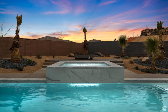 1516 W 800th Cir S, Hurricane, UT 84737 - pool at dusk featuring a fenced backyard, an in ground hot tub, and a fenced in pool