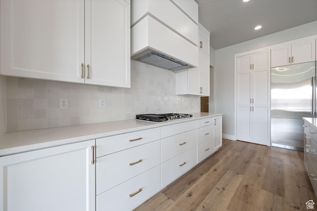 1516 W 800th Cir S, Hurricane, UT 84737 - kitchen with light wood-type flooring, custom range hood, gas stovetop, stainless steel built in refrigerator, and white cabinets