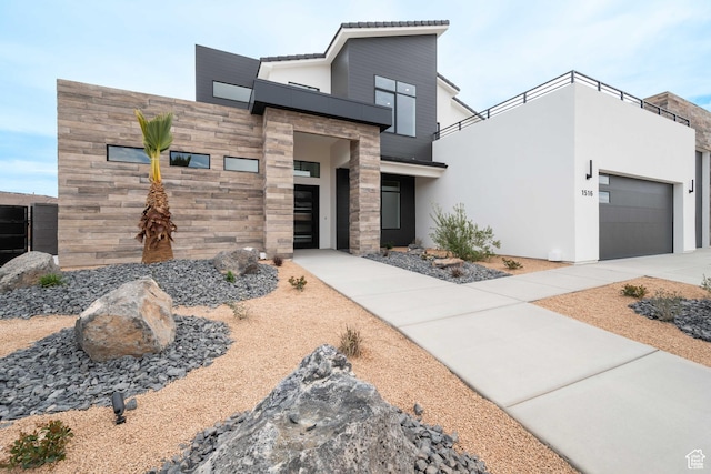 1516 W 800th Cir S, Hurricane, UT 84737 - contemporary house featuring a balcony, stone siding, a garage, concrete driveway, and stucco siding
