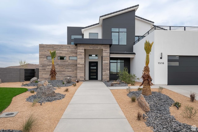 1516 W 800th Cir S, Hurricane, UT 84737 - contemporary home featuring stone siding, fence, an attached garage, stucco siding, and driveway