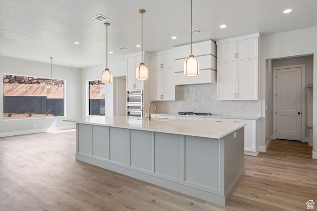 1516 W 800th Cir S, Hurricane, UT 84737 - kitchen featuring double oven, gas stovetop, light countertops, and white cabinets