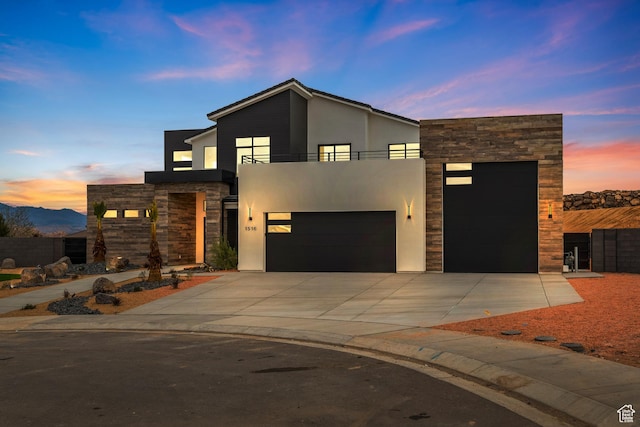 1516 W 800th Cir S, Hurricane, UT 84737 - contemporary home with stone siding, a balcony, driveway, and stucco siding