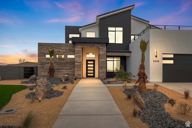 1516 W 800th Cir S, Hurricane, UT 84737 - contemporary house featuring concrete driveway, stucco siding, fence, stone siding, and a garage