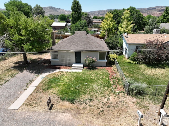 440 S 200 W, Richfield, UT 84701 - view of front of home featuring a fenced backyard, a mountain view, and a shingled roof