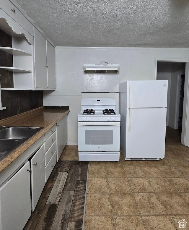 kitchen with a textured ceiling, under cabinet range hood, open shelves, and white appliances