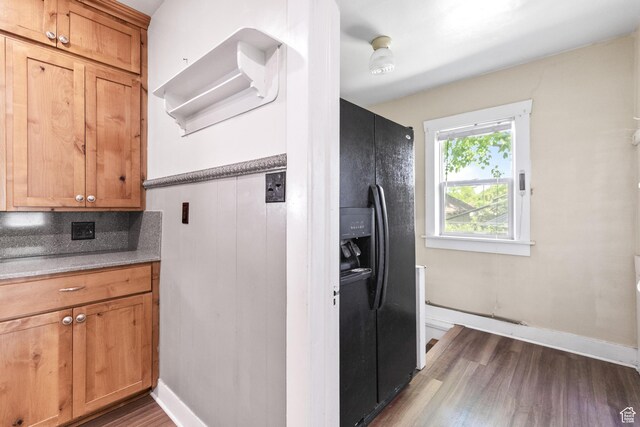 325 E 300 S, Logan, UT 84321 - kitchen with black refrigerator with ice dispenser, dark wood finished floors, brown cabinets, and decorative backsplash
