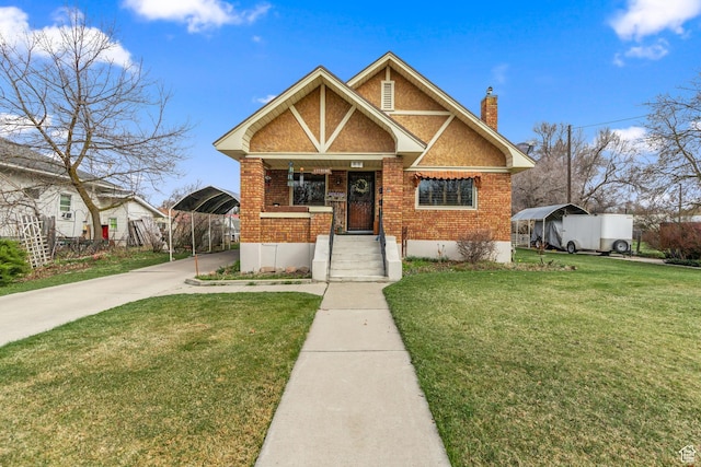325 E 300 S, Logan, UT 84321 - view of front of home featuring a chimney, a front lawn, concrete driveway, and brick siding
