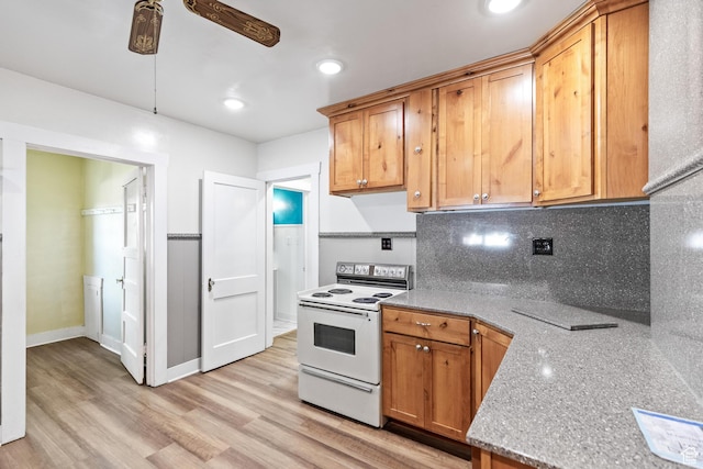 325 E 300 S, Logan, UT 84321 - kitchen with white electric stove, a ceiling fan, backsplash, light wood-style floors, and baseboards