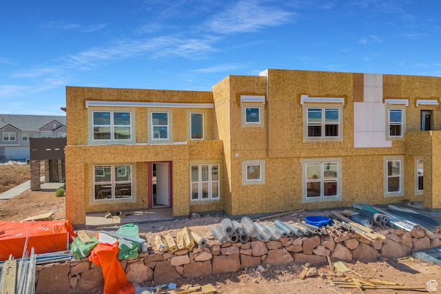 view of front facade with stucco siding and a patio area