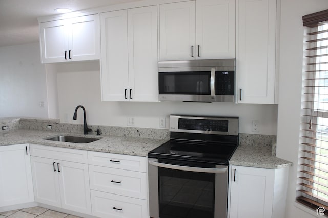 987 S 790 W, Lehi, UT 84043 - kitchen with white cabinetry, light stone countertops, a sink, and appliances with stainless steel finishes