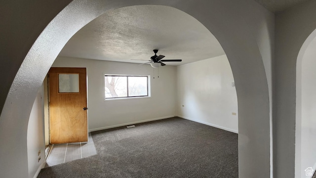 84 N 550 E, Spring City, UT 84662 - carpeted empty room featuring a textured ceiling, arched walkways, baseboards, and a ceiling fan