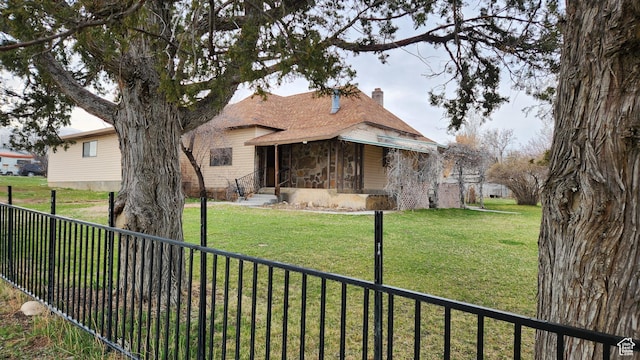 84 N 550 E, Spring City, UT 84662 - view of front facade with a front lawn, a chimney, stone siding, and fence private yard