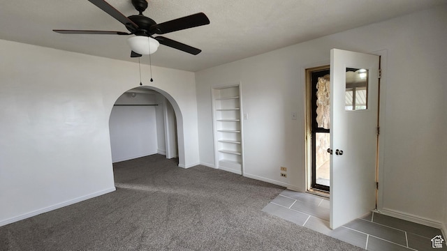 84 N 550 E, Spring City, UT 84662 - unfurnished room with carpet flooring, baseboards, ceiling fan, built in shelves, and arched walkways