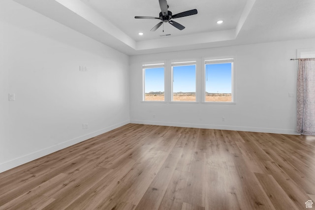 2841 N Rosie Loop N, Cedar City, UT 84721 - unfurnished room featuring a tray ceiling, baseboards, light wood finished floors, and recessed lighting