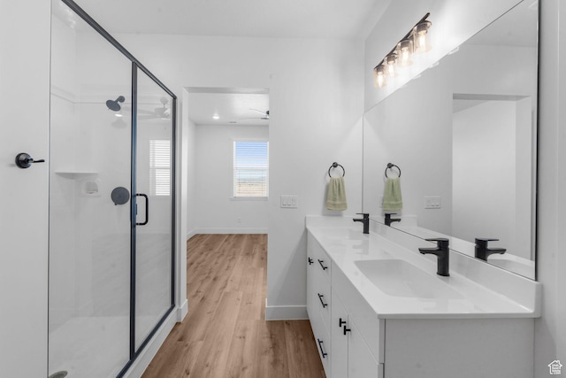 2841 N Rosie Loop N, Cedar City, UT 84721 - full bathroom with double vanity, a sink, a stall shower, and wood finished floors