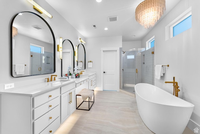 full bathroom with a soaking tub, vanity, a shower stall, and visible vents