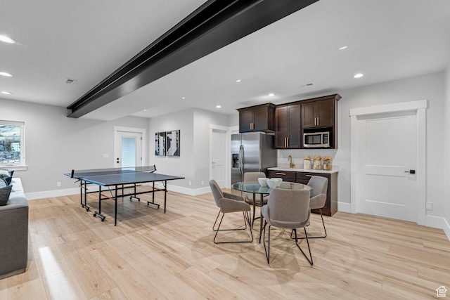 dining room featuring light wood finished floors, baseboards, and recessed lighting