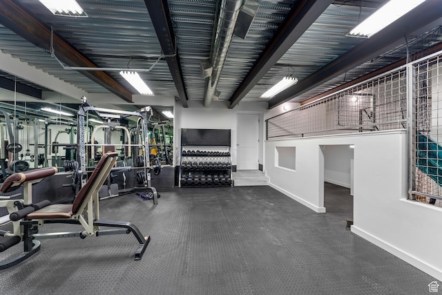 workout area featuring baseboards
