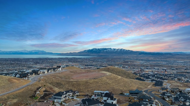 aerial view at dusk featuring a residential view and a mountain view