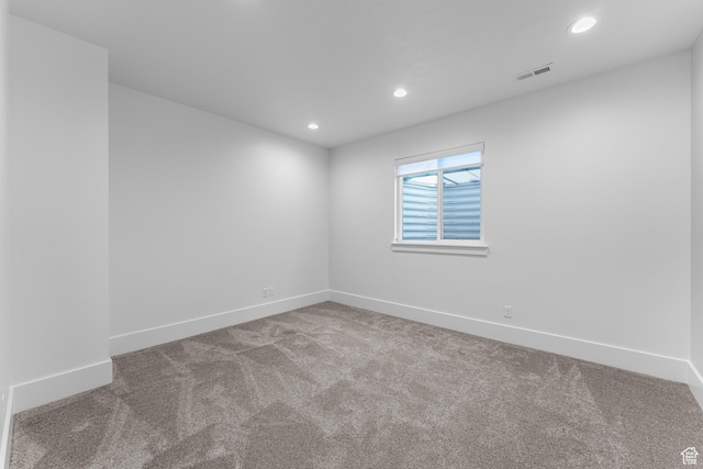 empty room with baseboards, visible vents, recessed lighting, and carpet flooring
