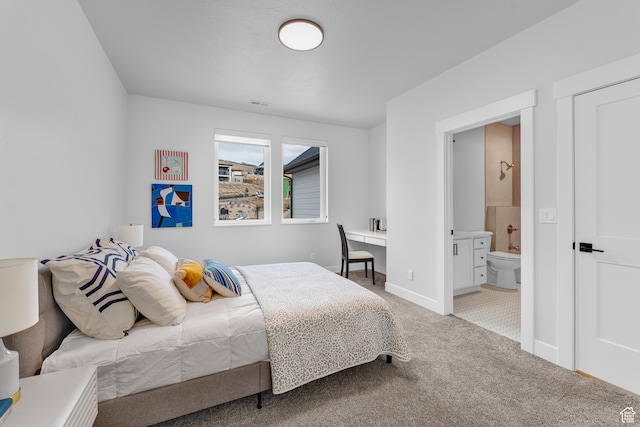 bedroom featuring baseboards, carpet flooring, and connected bathroom