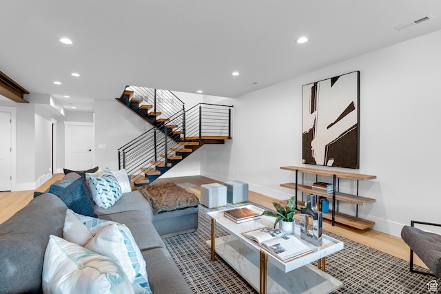 living room with stairs, recessed lighting, baseboards, light wood-style floors, and visible vents