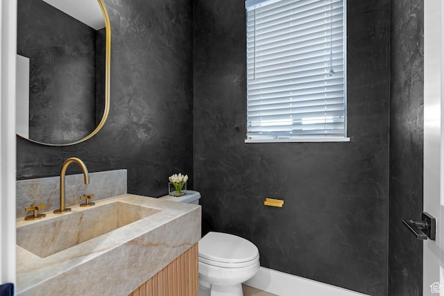 bathroom with toilet and vanity
