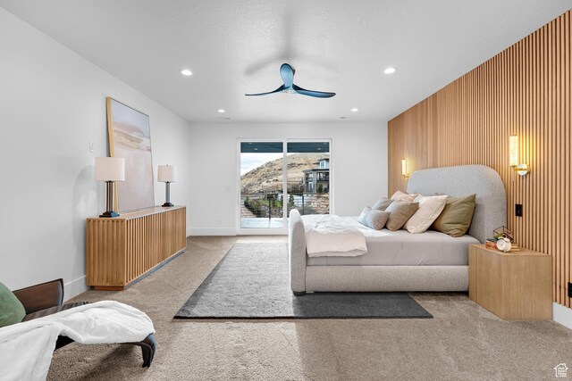 bedroom with wooden walls, carpet floors, recessed lighting, and a ceiling fan