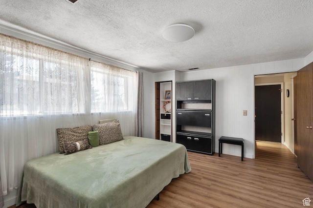 761 E Raygene Way S, North Salt Lake, UT 84054 - bedroom with visible vents, a textured ceiling, and wood finished floors