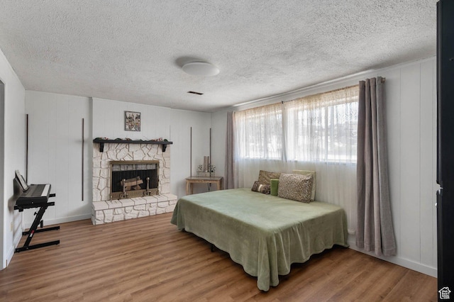761 E Raygene Way S, North Salt Lake, UT 84054 - bedroom featuring a fireplace, visible vents, wood finished floors, and a textured ceiling