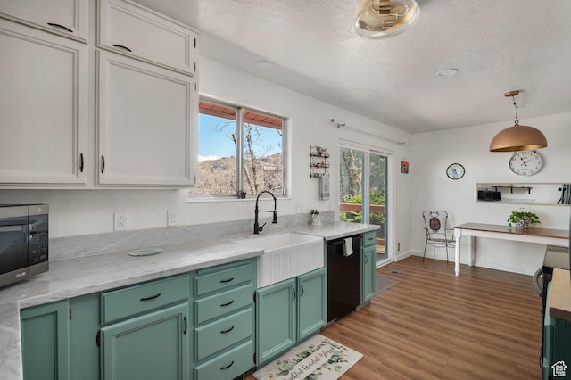 761 E Raygene Way S, North Salt Lake, UT 84054 - kitchen with a textured ceiling, light wood finished floors, stainless steel microwave, black dishwasher, and a sink