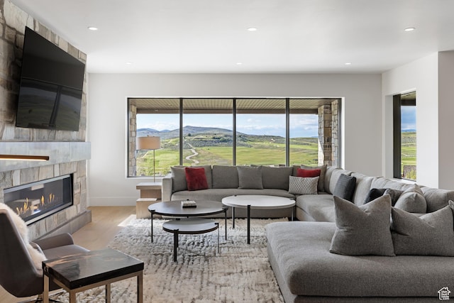 7045 E Moon Light Dr, Heber City, UT 84032 - living area with light wood finished floors, a fireplace, healthy amount of natural light, recessed lighting, and baseboards