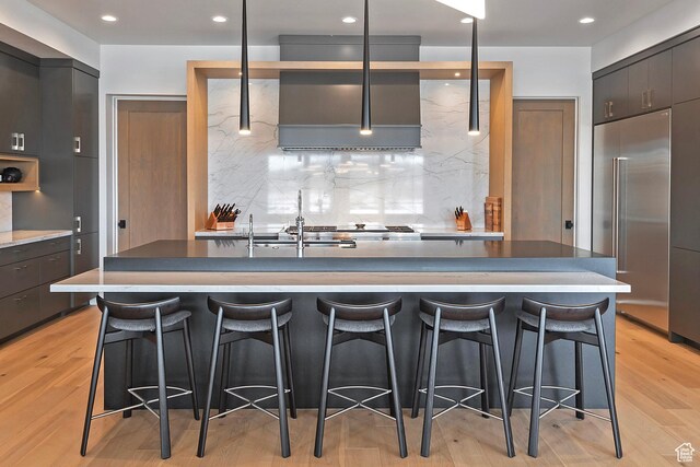 7045 E Moon Light Dr, Heber City, UT 84032 - kitchen featuring stainless steel built in fridge, modern cabinets, backsplash, a breakfast bar, and light wood finished floors