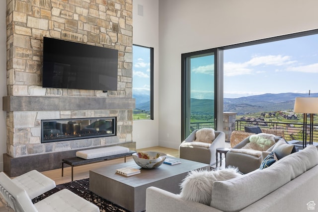 7045 E Moon Light Dr, Heber City, UT 84032 - living area with a stone fireplace, wood finished floors, and healthy amount of natural light