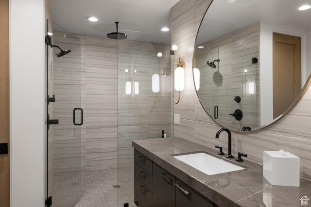 7045 E Moon Light Dr, Heber City, UT 84032 - bathroom featuring vanity, a stall shower, recessed lighting, and tile walls