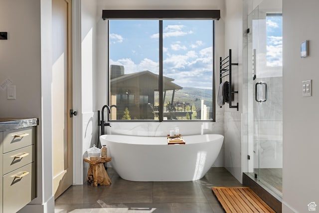 7045 E Moon Light Dr, Heber City, UT 84032 - full bathroom with a soaking tub, tile walls, a shower stall, and tile patterned floors