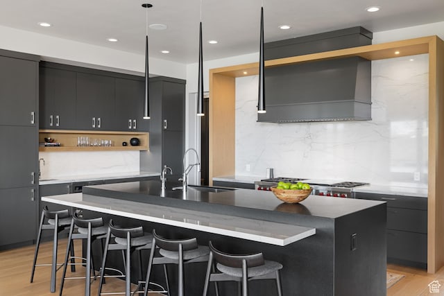 7045 E Moon Light Dr, Heber City, UT 84032 - kitchen featuring open shelves, a sink, a center island with sink, decorative backsplash, and a breakfast bar area