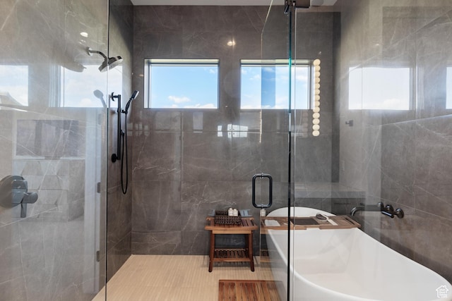 7045 E Moon Light Dr, Heber City, UT 84032 - full bathroom with a stall shower, a soaking tub, healthy amount of natural light, and tile walls