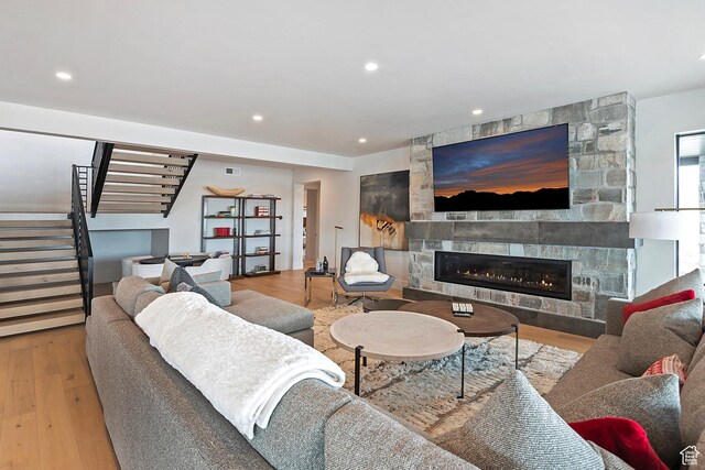 7045 E Moon Light Dr, Heber City, UT 84032 - living room featuring stairway, a stone fireplace, wood finished floors, and recessed lighting