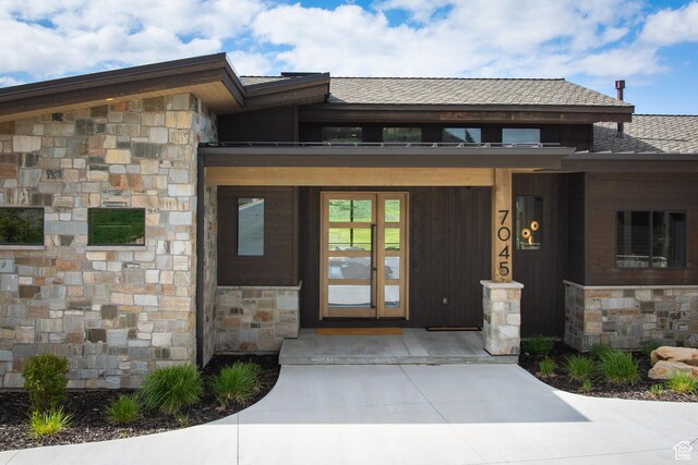 7045 E Moon Light Dr, Heber City, UT 84032 - property entrance with stone siding, covered porch, and a shingled roof
