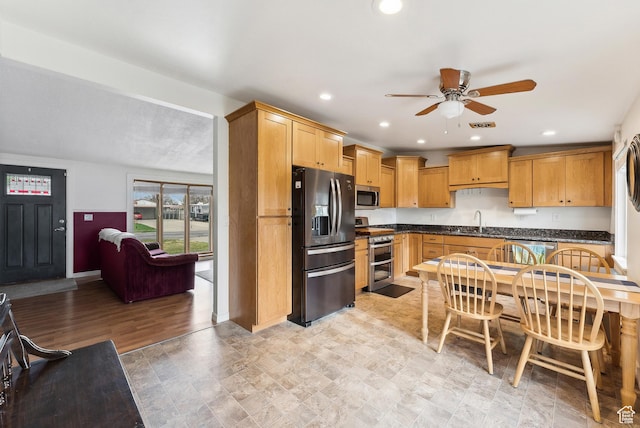 kitchen featuring a sink, dark countertops, visible vents, a ceiling fan, and appliances with stainless steel finishes