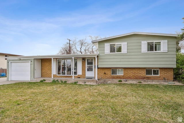 split level home with brick siding, a front yard, driveway, and an attached garage