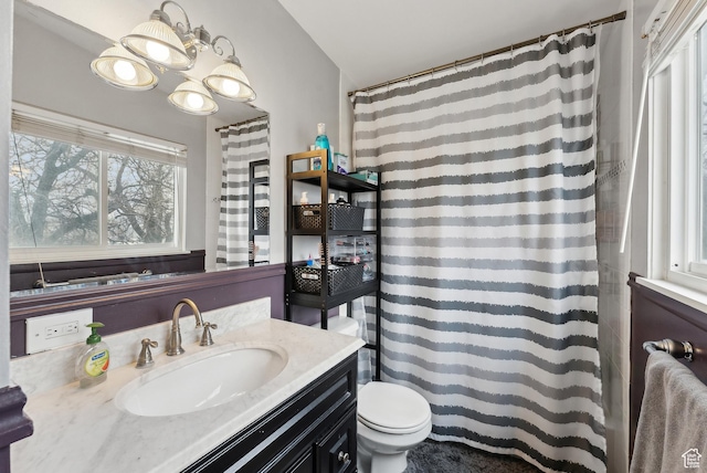 bathroom with toilet, a shower with shower curtain, and vanity