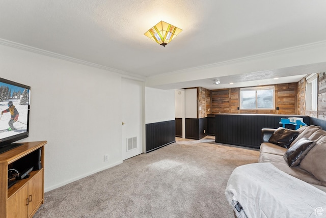living room featuring ornamental molding, visible vents, and light colored carpet