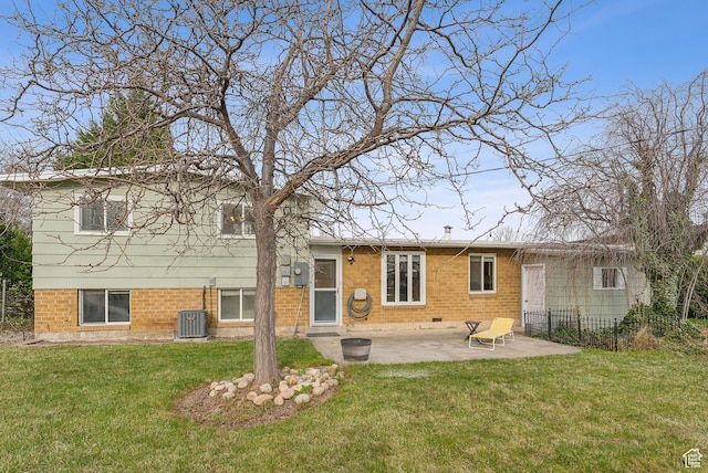 back of house featuring fence, central AC unit, a yard, and a patio area