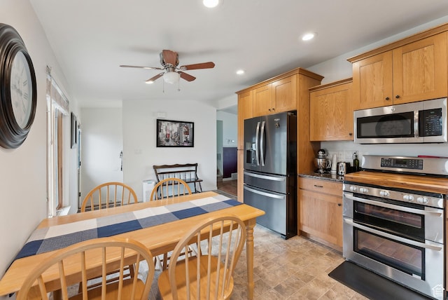 kitchen with ceiling fan, stainless steel appliances, recessed lighting, and dark countertops