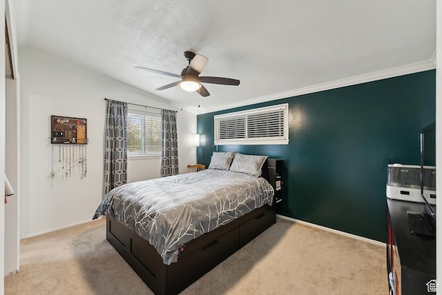 carpeted bedroom with baseboards, lofted ceiling, ceiling fan, and crown molding